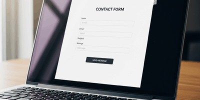 clean modern website contact form on laptop with email notification icons